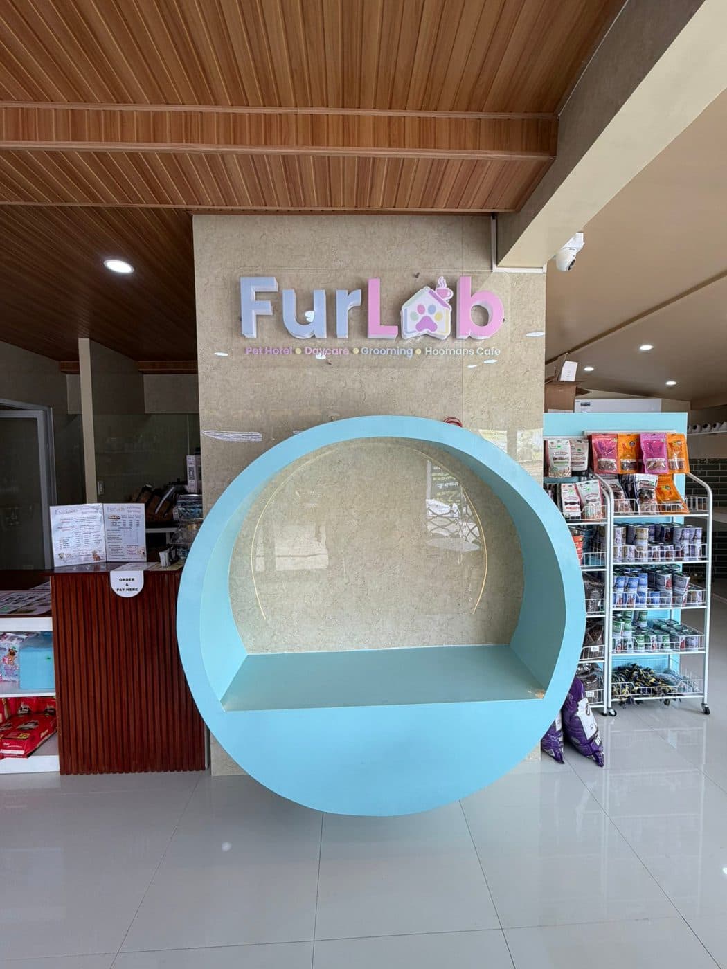 FurLab reception with the photo nook and shelves of pet food and supplies